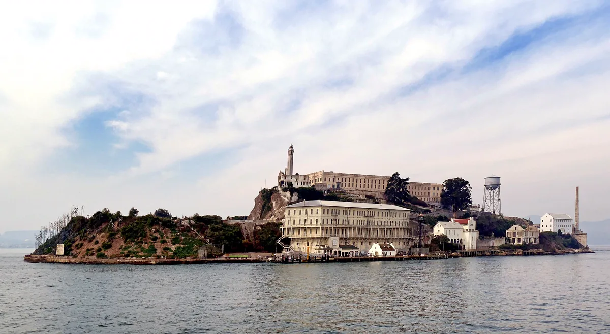 Alcatraz Island is located in San Francisco Bay, 1.25 miles (2.01 km) offshore from San Francisco, California, United States. The small island was developed with facilities for a lighthouse, a military fortification, a m